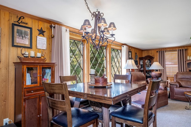 429 Pleasant Valley Rd, Marion, MT 59925 - dining room with a chandelier, wood walls, and light colored carpet