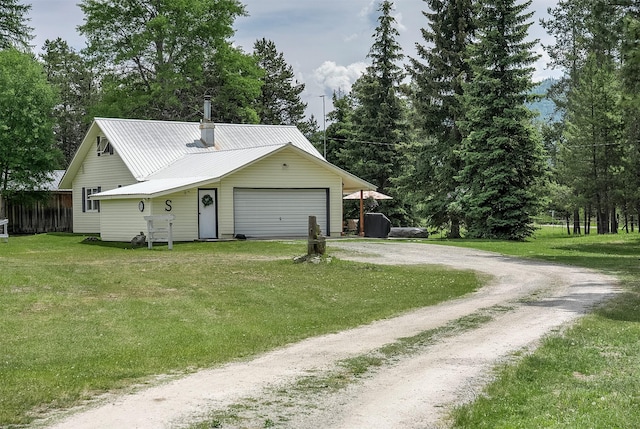429 Pleasant Valley Rd, Marion, MT 59925 - garage with dirt driveway and view of wooded area