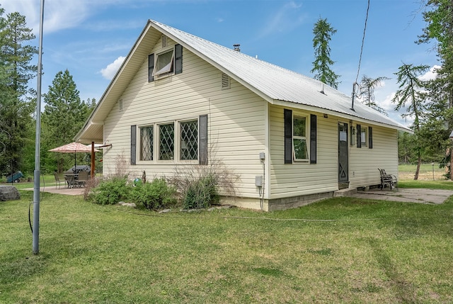 429 Pleasant Valley Rd, Marion, MT 59925 - view of property exterior with a patio area, a yard, and a metal roof