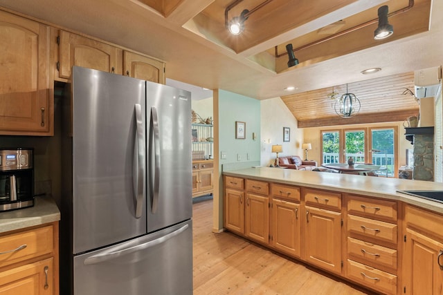 7 Eagle Bend Dr, Bigfork, MT 59911 - kitchen with freestanding refrigerator, light wood-style flooring, light countertops, recessed lighting, and vaulted ceiling