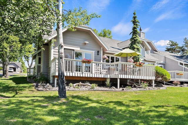 7 Eagle Bend Dr, Bigfork, MT 59911 - rear view of house with a deck, a yard, and roof with shingles