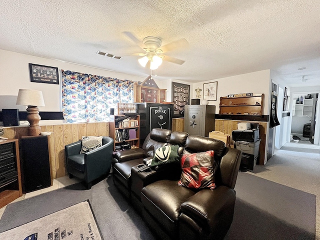 643 Madison Way, Great Falls, MT 59404 - living room with a ceiling fan, carpet floors, a textured ceiling, wainscoting, and wood walls