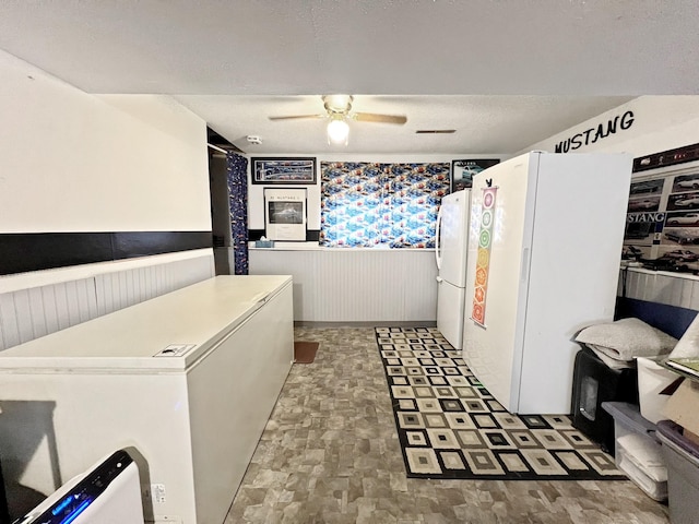 643 Madison Way, Great Falls, MT 59404 - kitchen with freestanding refrigerator, a wainscoted wall, ceiling fan, and fridge