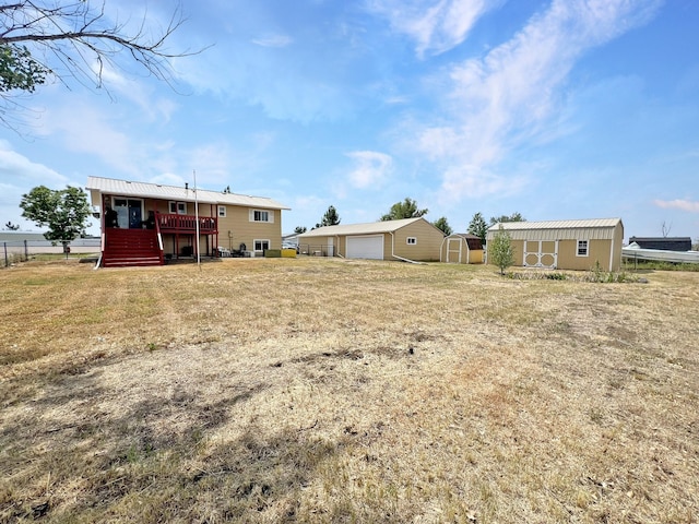 643 Madison Way, Great Falls, MT 59404 - rear view of property featuring a storage shed, a garage, a wooden deck, and stairway