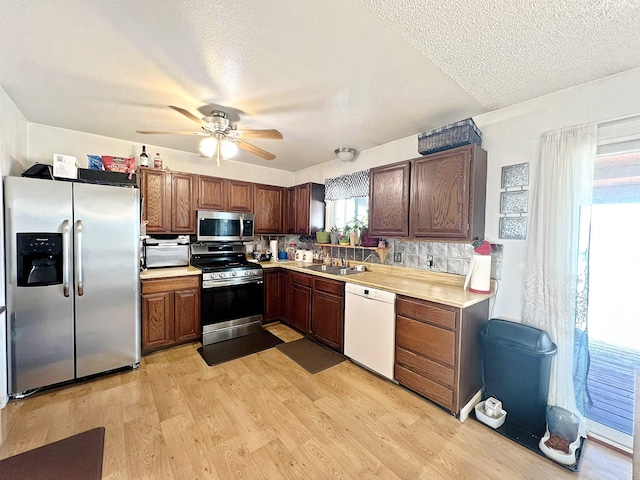 643 Madison Way, Great Falls, MT 59404 - kitchen featuring stainless steel appliances, light countertops, light wood-style floors, ceiling fan, and a textured ceiling
