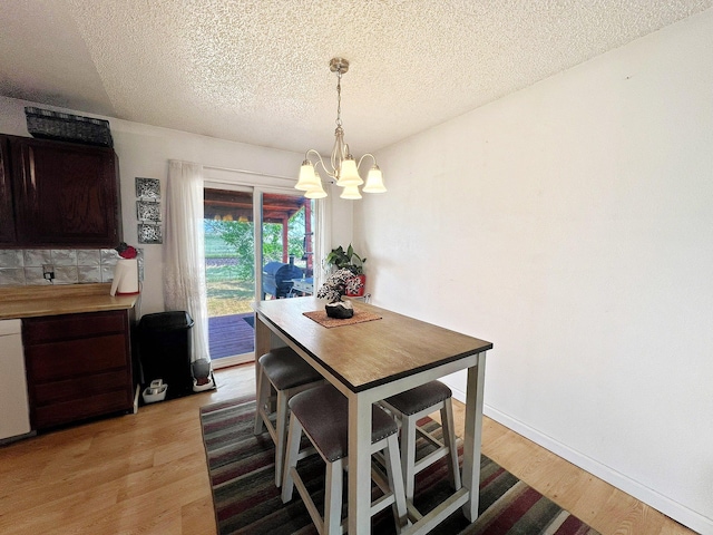 643 Madison Way, Great Falls, MT 59404 - dining area with a chandelier, light wood-type flooring, and a textured ceiling