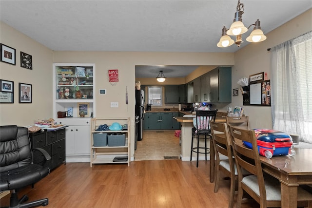 521 2nd Ave SW, Great Falls, MT 59404 - dining room with light wood-type flooring, healthy amount of natural light, and a chandelier