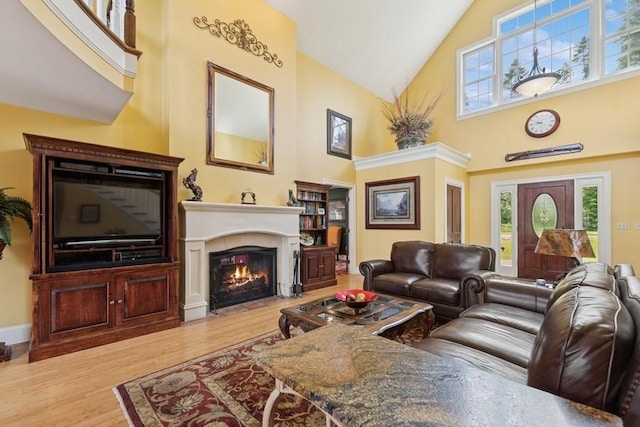 420 Little Creek Ln, Whitefish, MT 59937 - living area with high vaulted ceiling, wood finished floors, and a fireplace with flush hearth