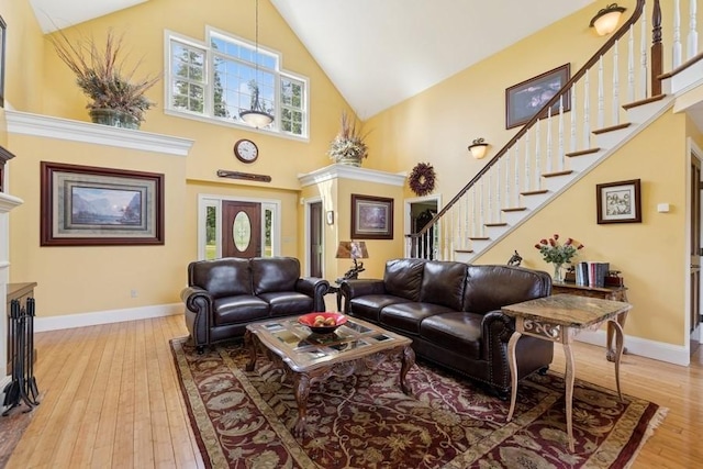 420 Little Creek Ln, Whitefish, MT 59937 - living area featuring high vaulted ceiling, stairway, light wood-type flooring, and a fireplace