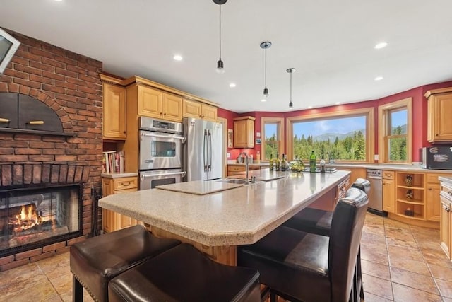 420 Little Creek Ln, Whitefish, MT 59937 - kitchen featuring stainless steel appliances, a center island with sink, recessed lighting, pendant lighting, and a kitchen bar