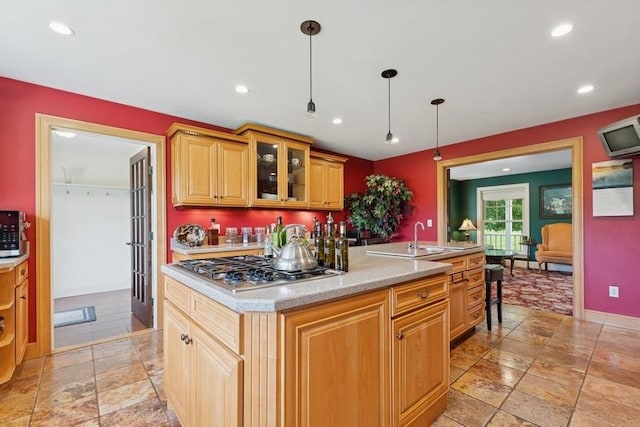 420 Little Creek Ln, Whitefish, MT 59937 - kitchen featuring stainless steel gas stovetop, light countertops, stone tile flooring, recessed lighting, and glass insert cabinets