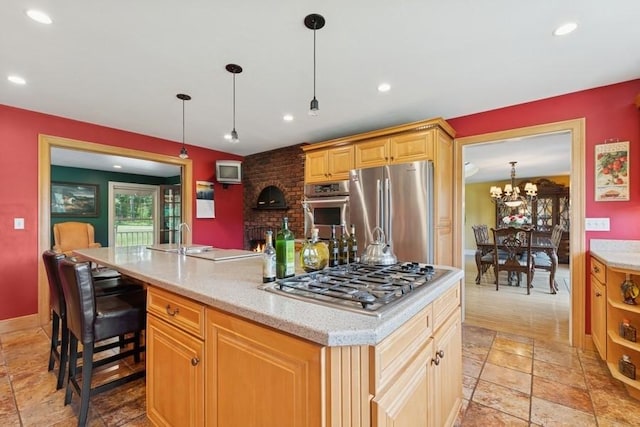 420 Little Creek Ln, Whitefish, MT 59937 - kitchen with stainless steel appliances, a center island, stone tile flooring, recessed lighting, and decorative light fixtures