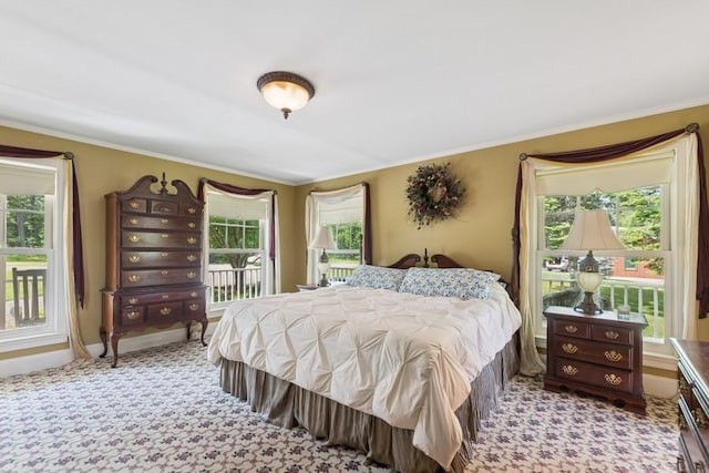 420 Little Creek Ln, Whitefish, MT 59937 - bedroom with multiple windows, access to exterior, ornamental molding, and light carpet