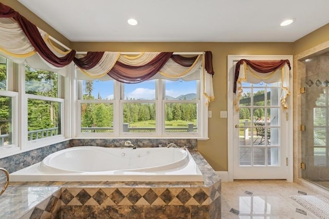 420 Little Creek Ln, Whitefish, MT 59937 - bathroom featuring a garden tub, plenty of natural light, a shower stall, and recessed lighting
