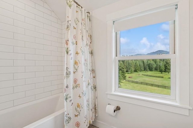 420 Little Creek Ln, Whitefish, MT 59937 - bathroom featuring shower / bath combo with shower curtain and vaulted ceiling