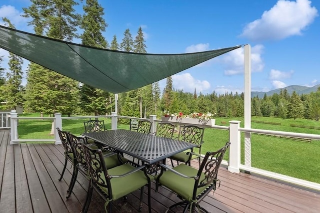 420 Little Creek Ln, Whitefish, MT 59937 - wooden terrace featuring a yard, outdoor dining area, a forest view, and a mountain view