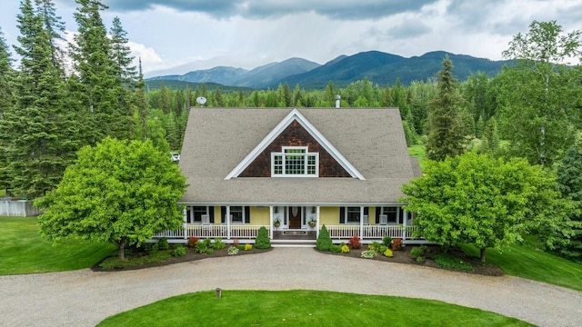 420 Little Creek Ln, Whitefish, MT 59937 - view of front facade featuring a porch, a mountain view, and gravel driveway