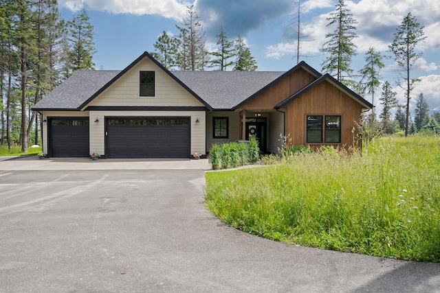 331 Deer Creek Rd, Somers, MT 59932 - view of front of property featuring driveway, a garage, and roof with shingles