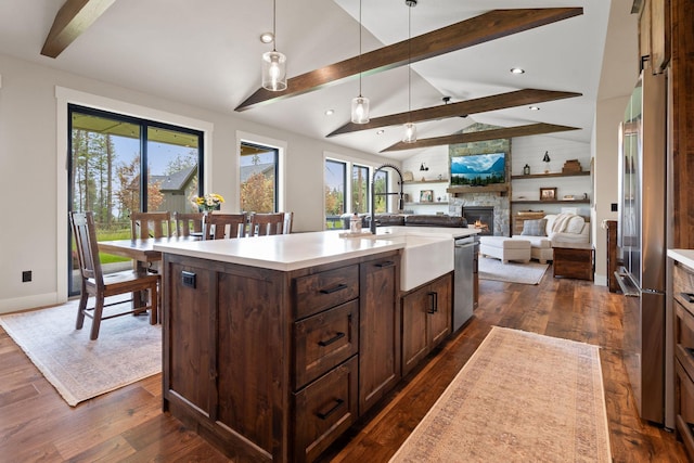 331 Deer Creek Rd, Somers, MT 59932 - kitchen featuring a stone fireplace, dishwasher, dark wood-style flooring, dark brown cabinets, and recessed lighting