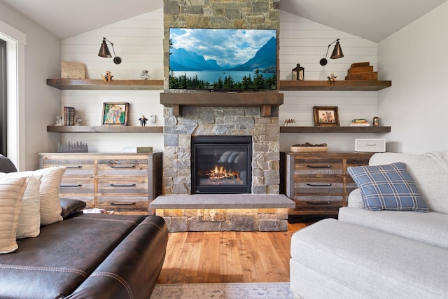 331 Deer Creek Rd, Somers, MT 59932 - living room featuring vaulted ceiling, wood finished floors, a fireplace, and wood walls
