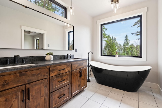 331 Deer Creek Rd, Somers, MT 59932 - full bath with healthy amount of natural light, double vanity, a freestanding tub, and tile patterned floors