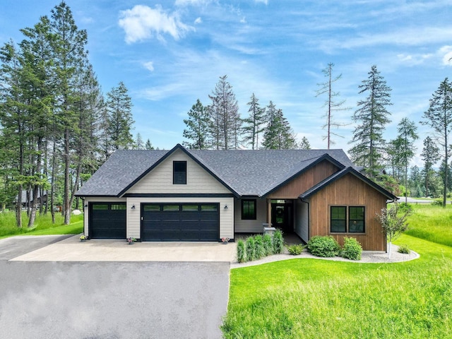 331 Deer Creek Rd, Somers, MT 59932 - view of front of home with driveway, roof with shingles, a front lawn, and an attached garage