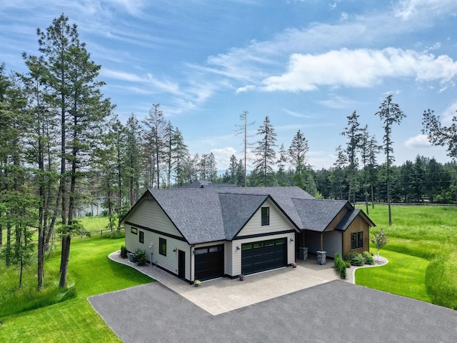 331 Deer Creek Rd, Somers, MT 59932 - modern farmhouse with driveway, a garage, a front lawn, and a shingled roof