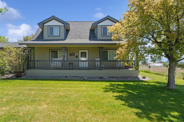 4786 Hereford Ln, Stevensville, MT 59870 - view of front of home featuring a porch, a front yard, and a shingled roof