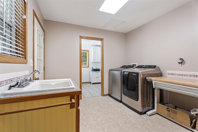 4786 Hereford Ln, Stevensville, MT 59870 - laundry area with washing machine and clothes dryer, attic access, and light tile patterned flooring