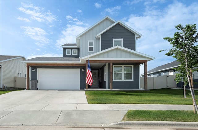 343 Meadow View Loop, East Helena, MT 59635 - view of front facade with board and batten siding, driveway, an attached garage, and a porch