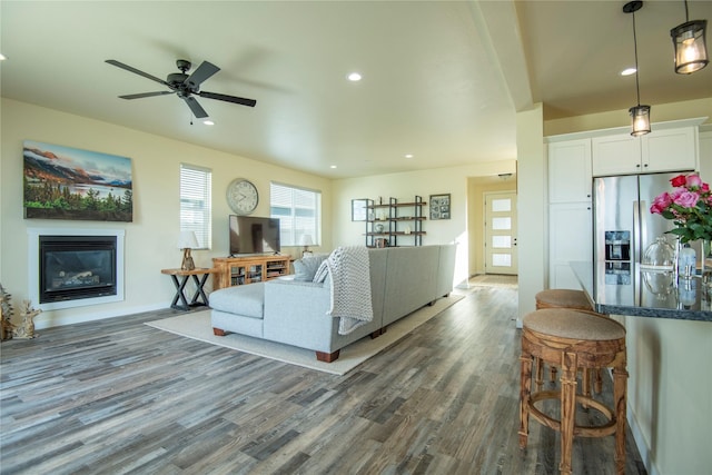 343 Meadow View Loop, East Helena, MT 59635 - living room featuring dark wood finished floors, a glass covered fireplace, healthy amount of natural light, ceiling fan, and recessed lighting