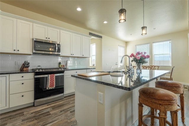 343 Meadow View Loop, East Helena, MT 59635 - kitchen featuring stainless steel appliances, dark wood-style flooring, decorative backsplash, recessed lighting, and white cabinets