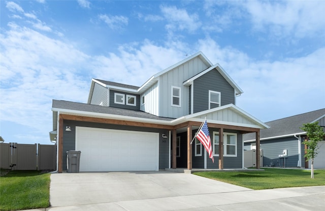 343 Meadow View Loop, East Helena, MT 59635 - view of front of home with board and batten siding, a porch, driveway, a gate, and a garage