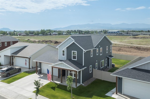 343 Meadow View Loop, East Helena, MT 59635 - view of front of home with board and batten siding, a mountain view, a shingled roof, and driveway