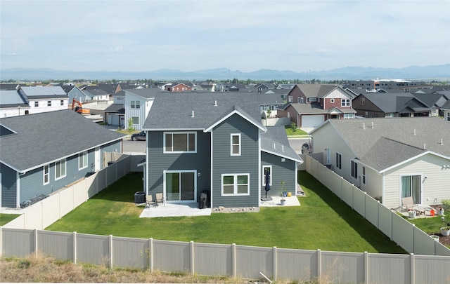 343 Meadow View Loop, East Helena, MT 59635 - rear view of property featuring a residential view, a patio area, a mountain view, a fenced backyard, and a shingled roof
