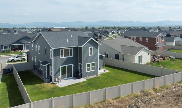 343 Meadow View Loop, East Helena, MT 59635 - rear view of house with a residential view, a mountain view, a patio, and a fenced backyard