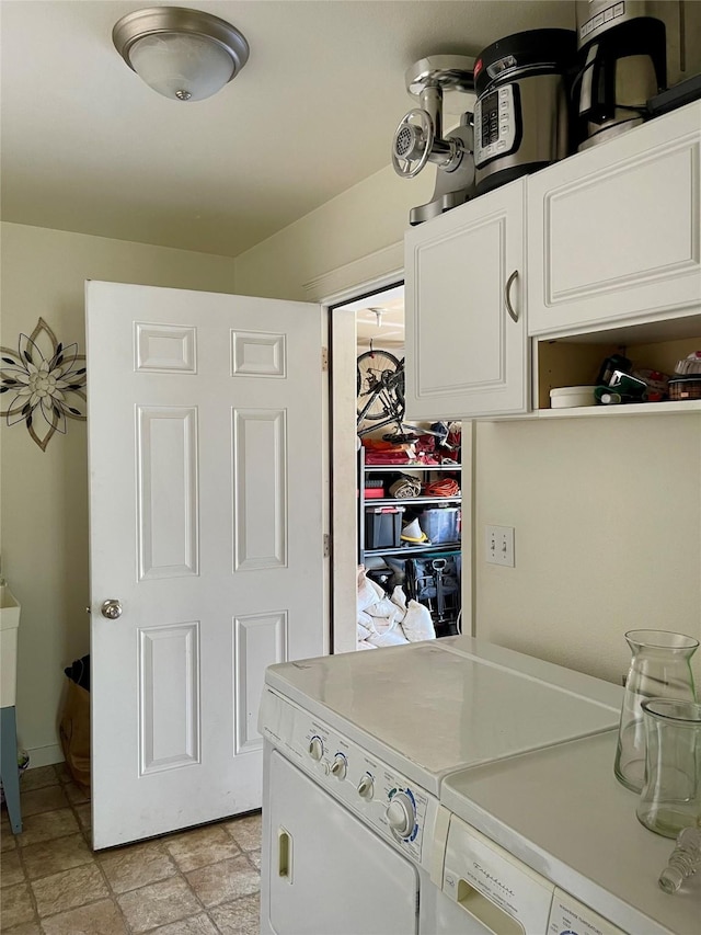 50 Rockefeller Dr, Kalispell, MT 59901 - washroom featuring cabinet space, separate washer and dryer, and light stone finish floors
