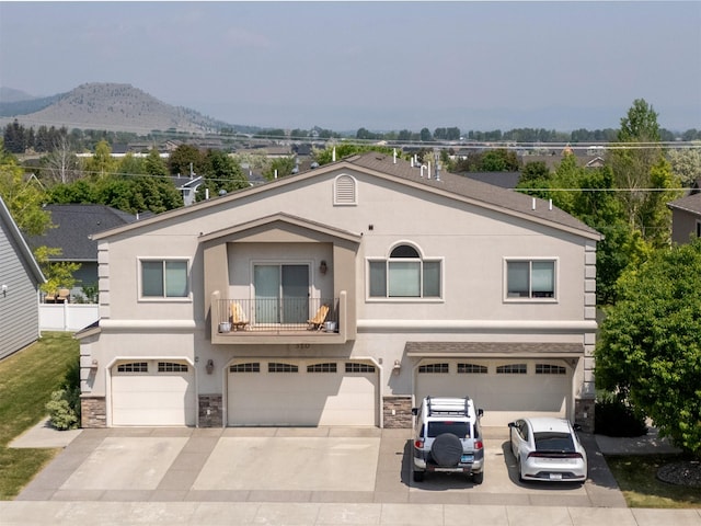 310 Barney St Unit B, Helena, MT 59602 - view of front of house featuring stucco siding, driveway, and a garage