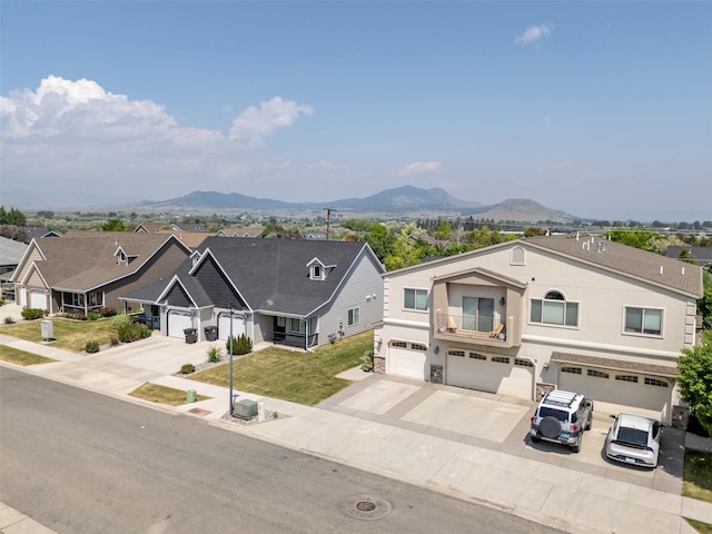 310 Barney St Unit B, Helena, MT 59602 - view of front facade with a mountain view, a garage, concrete driveway, and stucco siding