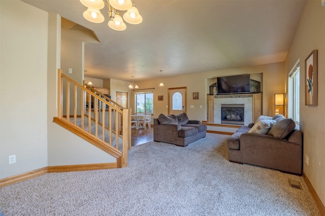 310 Barney St Unit B, Helena, MT 59602 - living area featuring a chandelier, carpet, stairway, and a tiled fireplace