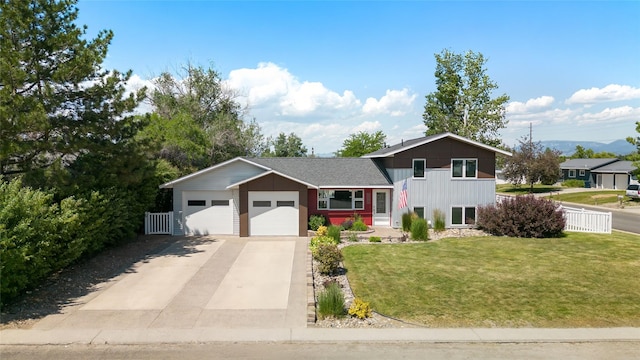 3782 E Riggs St, East Helena, MT 59635 - split level home featuring concrete driveway, an attached garage, and board and batten siding