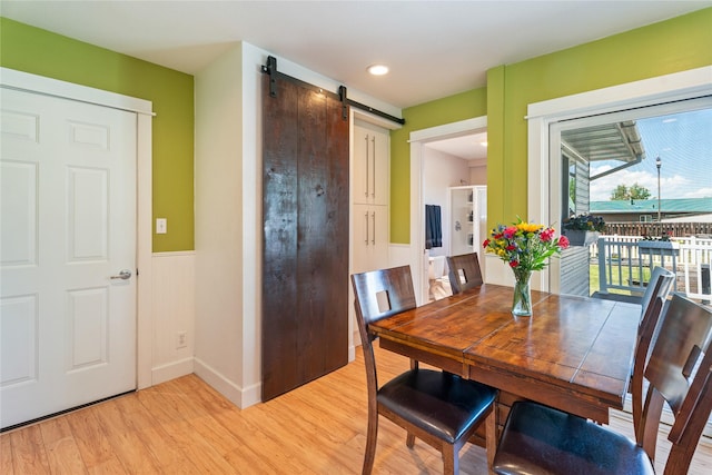 3782 E Riggs St, East Helena, MT 59635 - dining space with a barn door, wainscoting, and light wood finished floors
