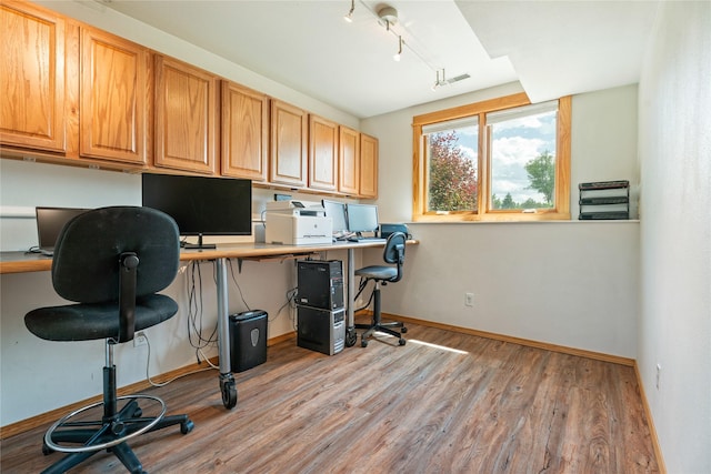 3782 E Riggs St, East Helena, MT 59635 - office with built in desk, light wood-style flooring, and track lighting