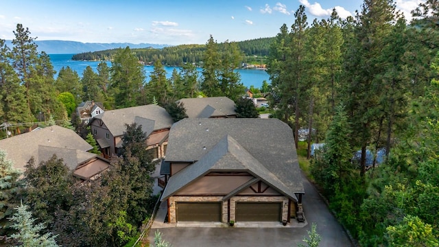 396 N Juniper Bay Rd Unit 15, Somers, MT 59932 - aerial view of property and surrounding area featuring a heavily wooded area and a water and mountain view