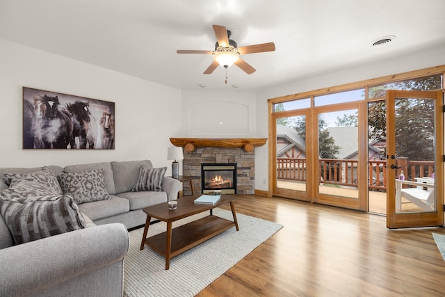 396 N Juniper Bay Rd Unit 15, Somers, MT 59932 - living room featuring light wood-style flooring, a fireplace, and ceiling fan