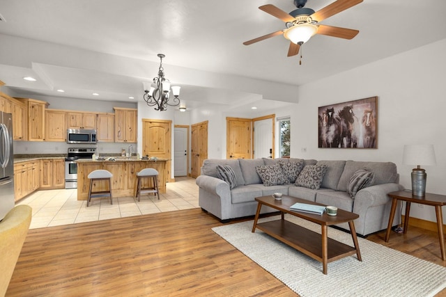396 N Juniper Bay Rd Unit 15, Somers, MT 59932 - living room with a chandelier, recessed lighting, light wood finished floors, and a ceiling fan