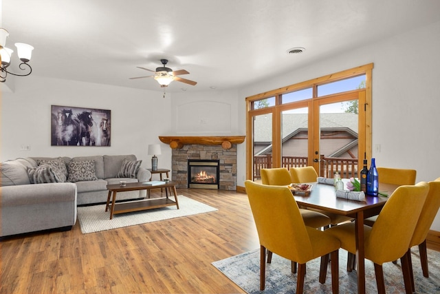 396 N Juniper Bay Rd Unit 15, Somers, MT 59932 - dining space with light wood finished floors, ceiling fan, and a fireplace
