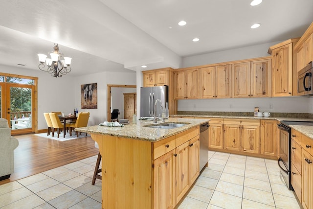 396 N Juniper Bay Rd Unit 15, Somers, MT 59932 - kitchen with appliances with stainless steel finishes, light tile patterned floors, recessed lighting, a chandelier, and an island with sink