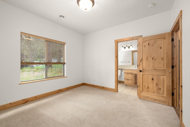 396 N Juniper Bay Rd Unit 15, Somers, MT 59932 - unfurnished bedroom with light colored carpet and ensuite bath