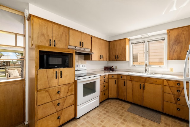 1120 8th Ave E, Kalispell, MT 59901 - kitchen featuring white electric range, black microwave, under cabinet range hood, and light countertops